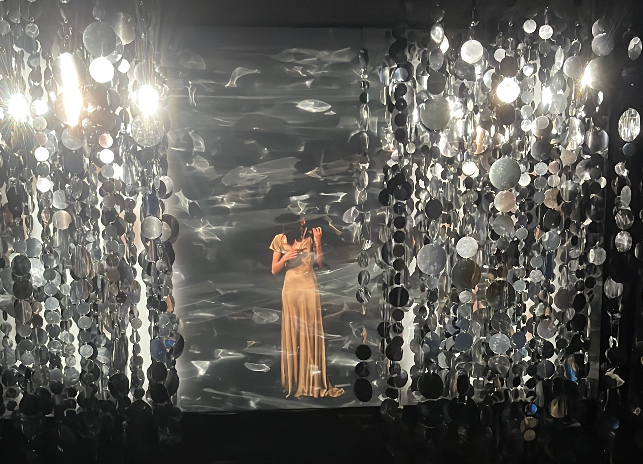 Sequin chamber with figure and projected water